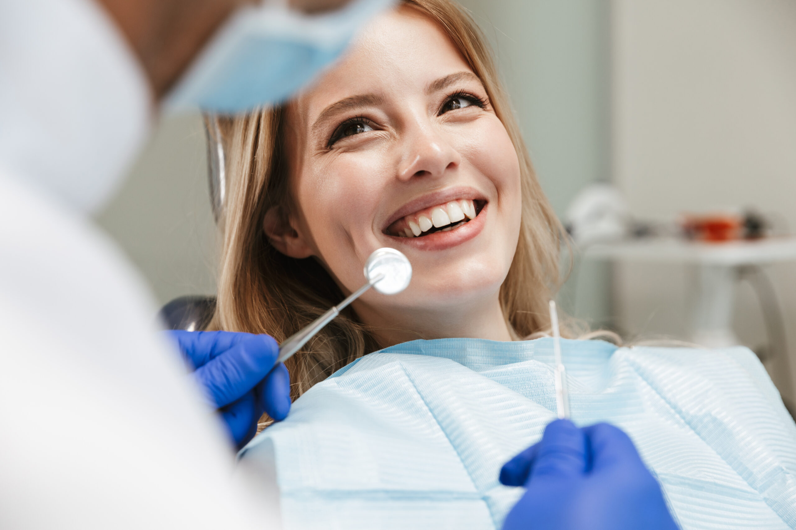 歯医者で治療中の女性が微笑んでいる